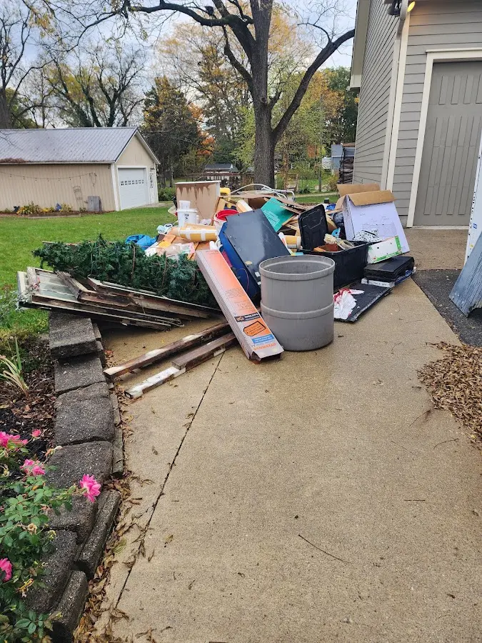Dumpster being loaded with debris for Estate Cleanout Dumpster Rental in Ripley